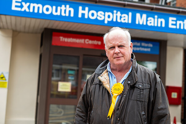 Paul Arnott in front of the main entrance to Exmouth Hospital